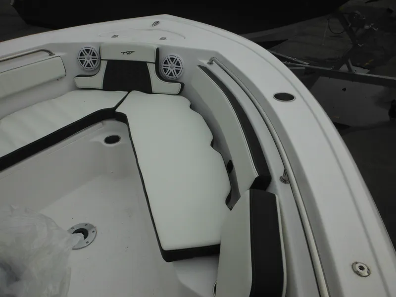Slide: The Image of 2024 Tidewater 210 LXF boat with white cushioned seating and built-in speakers. - 34