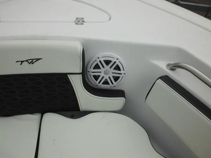 Slide: The Image of 2024 Tidewater 210 LXF boat interior with speaker and cushioned seating. - 38