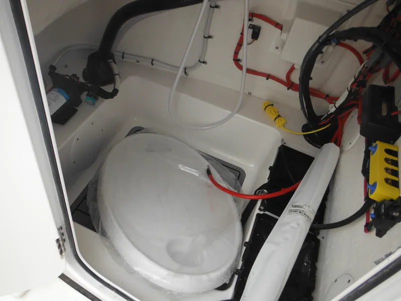 Slide: The Image of 2024 Tidewater 210 LXF boat interior with marine toilet and wiring. - 46