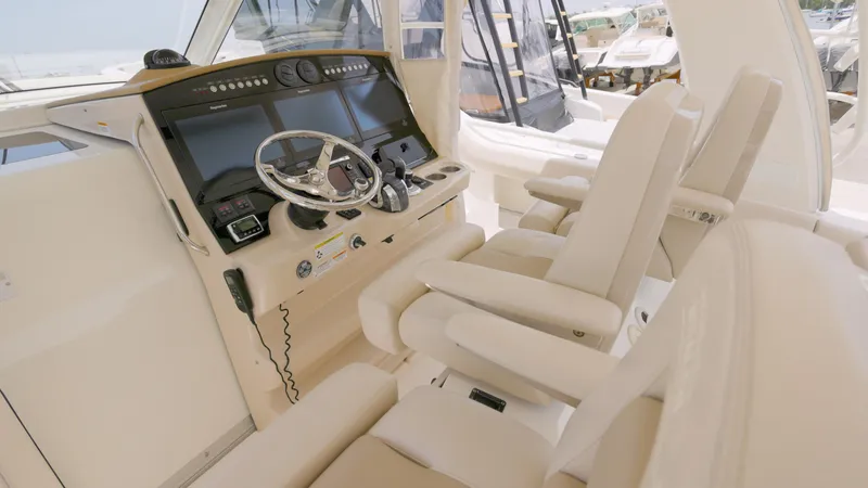 Slide: The Image of 2016 Boston Whaler 420 Outrage helm with luxurious seating and advanced navigation controls. - 10