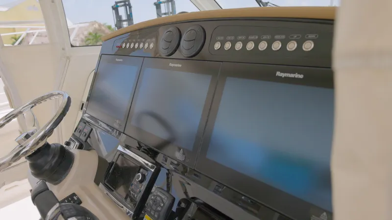 Slide: The Image of 2016 Boston Whaler 420 Outrage helm with Raymarine displays and steering wheel. - 11