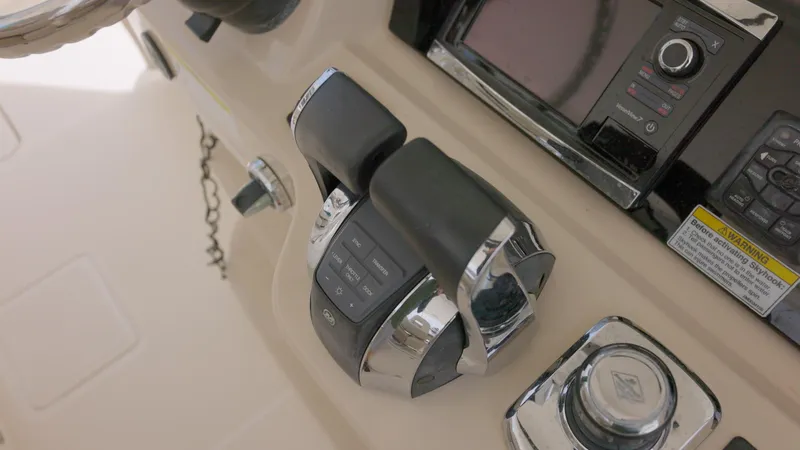 Slide: The Image of Close-up of the 2016 Boston Whaler 420 Outrage throttle controls and navigation system. - 13