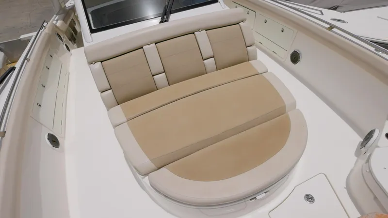 Slide: The Image of 2016 Boston Whaler 420 Outrage boat with beige cushioned seating area. - 17