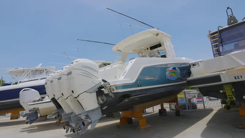 Slide: The Image of 2016 Boston Whaler 420 Outrage boat with triple outboard engines on display. - 5