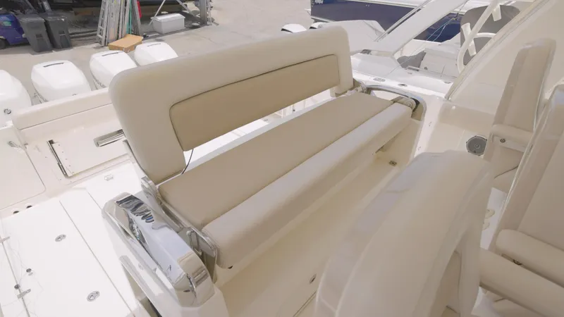 Slide: The Image of 2016 Boston Whaler 420 Outrage boat seating area with beige cushions. - 7