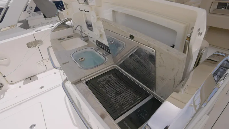 Slide: The Image of 2016 Boston Whaler 420 Outrage boat kitchen area with sink and grill. - 9