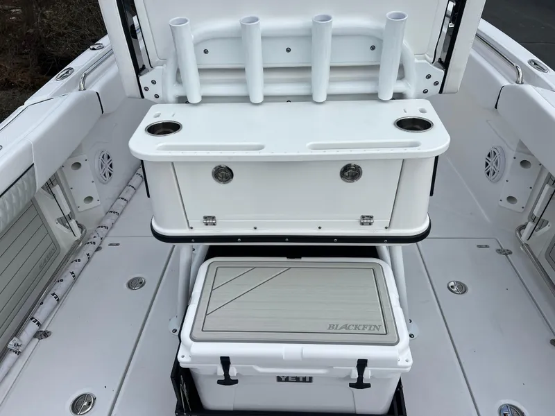 Slide: The Image of 2024 Blackfin 252 CC boat deck with rod holders and YETI cooler. - 15