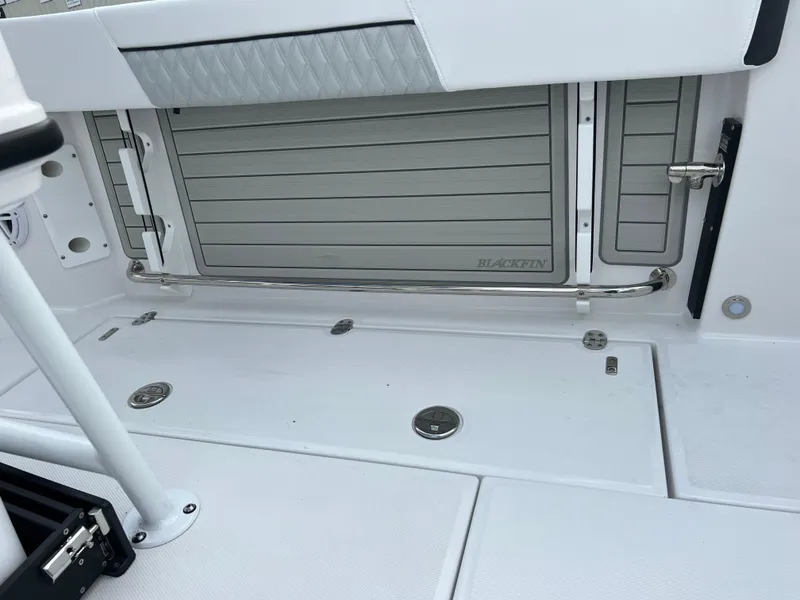 Slide: The Image of 2024 Blackfin 252 CC boat deck with storage compartments and stainless steel rail. - 20