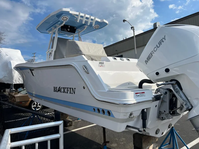 Slide: The Image of 2024 Blackfin 252 CC boat with Mercury outboard motor in a marina. - 3