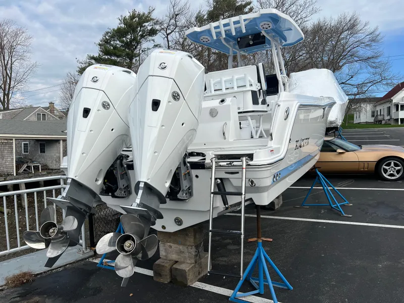 Slide: The Image of 2024 Blackfin 252 CC boat with twin outboard engines on stands. - 4