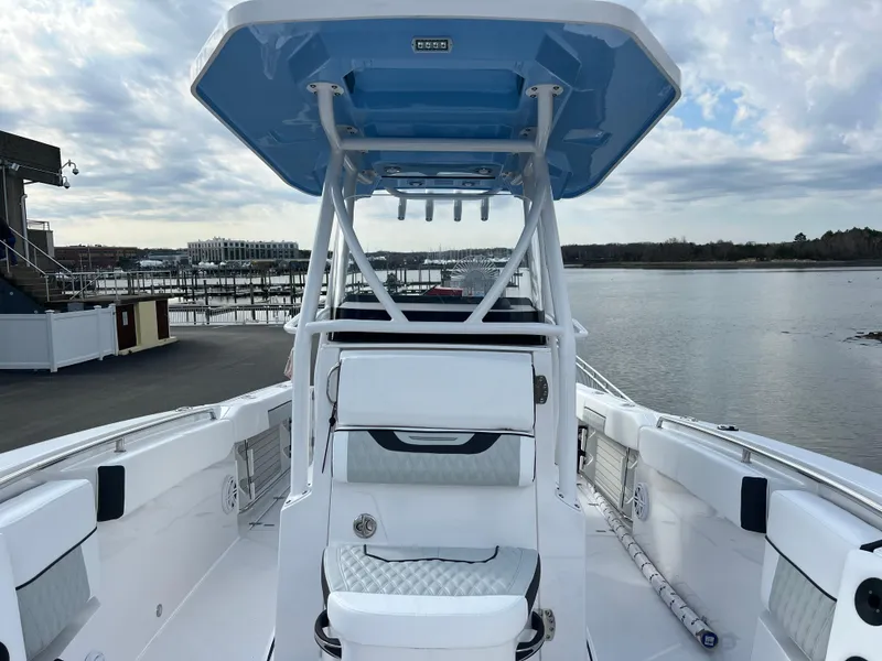 Slide: The Image of 2024 Blackfin 252 CC boat docked by the waterfront. - 9