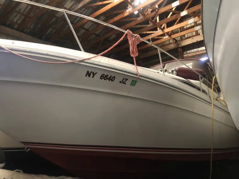 The Image of 1989 Sea Ray 280 Sundancer boat stored indoors, side view. - 0