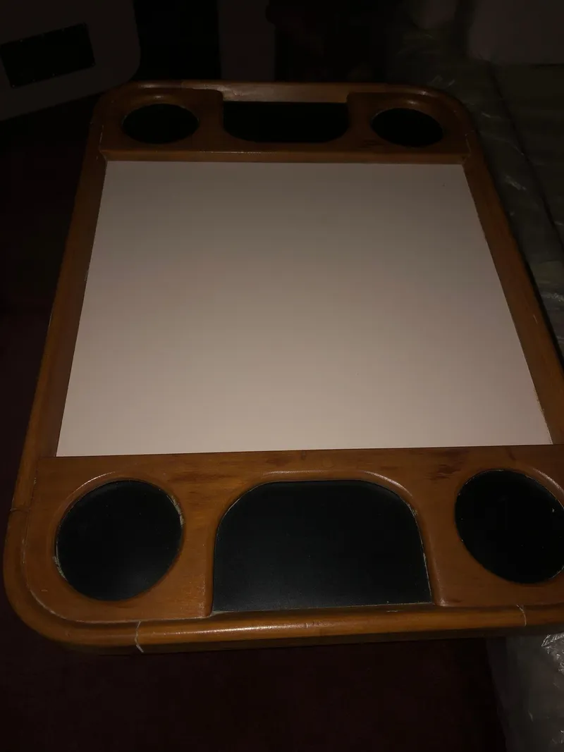 Slide: The Image of Wooden table with cup holders, likely from a 1989 Sea Ray 280 Sundancer boat. - 15