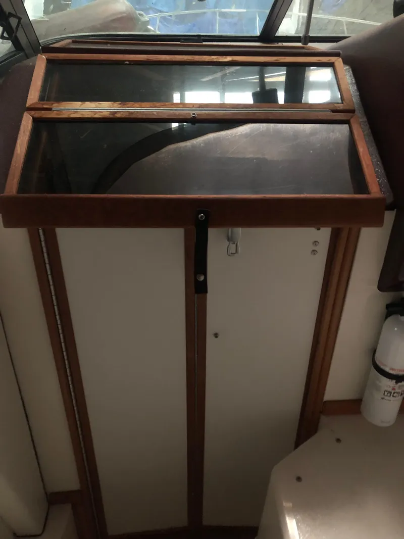 Slide: The Image of 1989 Sea Ray 280 Sundancer cabin door with wooden frame and glass panel. - 2