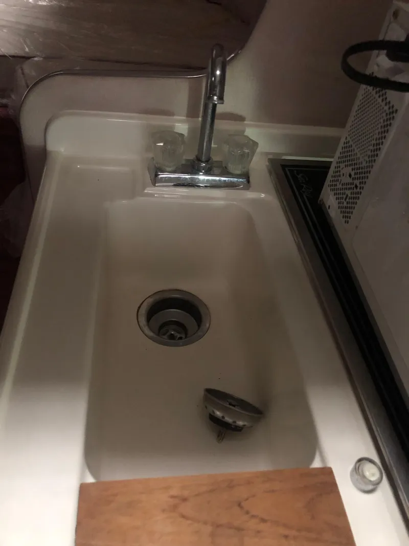 Slide: The Image of 1989 Sea Ray 280 Sundancer kitchen sink with faucet and countertop. - 21