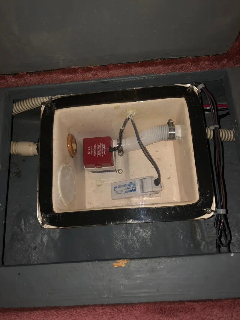 Slide: The Image of 1989 Sea Ray 280 Sundancer bilge compartment with pump and wiring. - 23