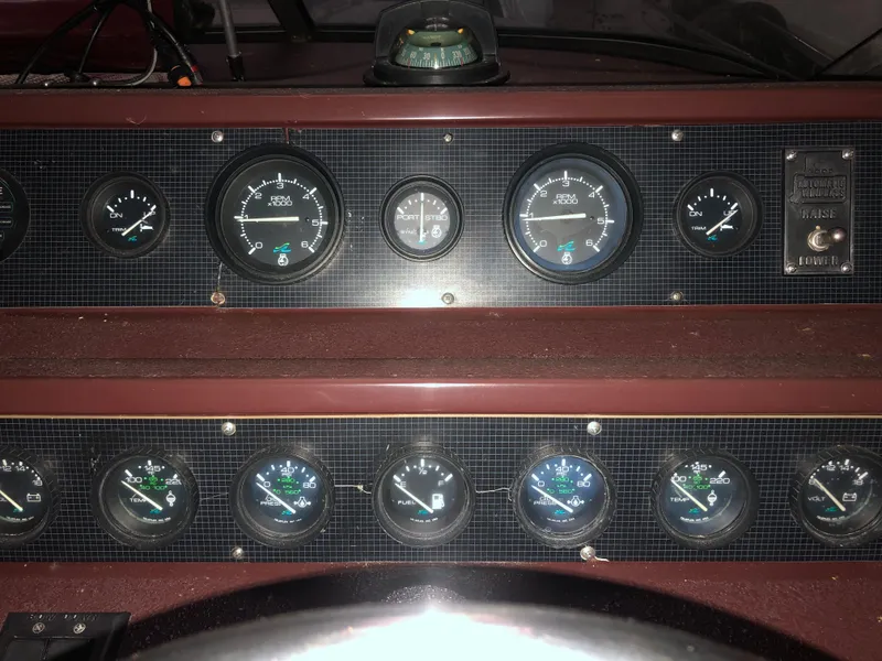 Slide: The Image of Dashboard of a 1989 Sea Ray 280 Sundancer boat with various gauges and controls. - 32