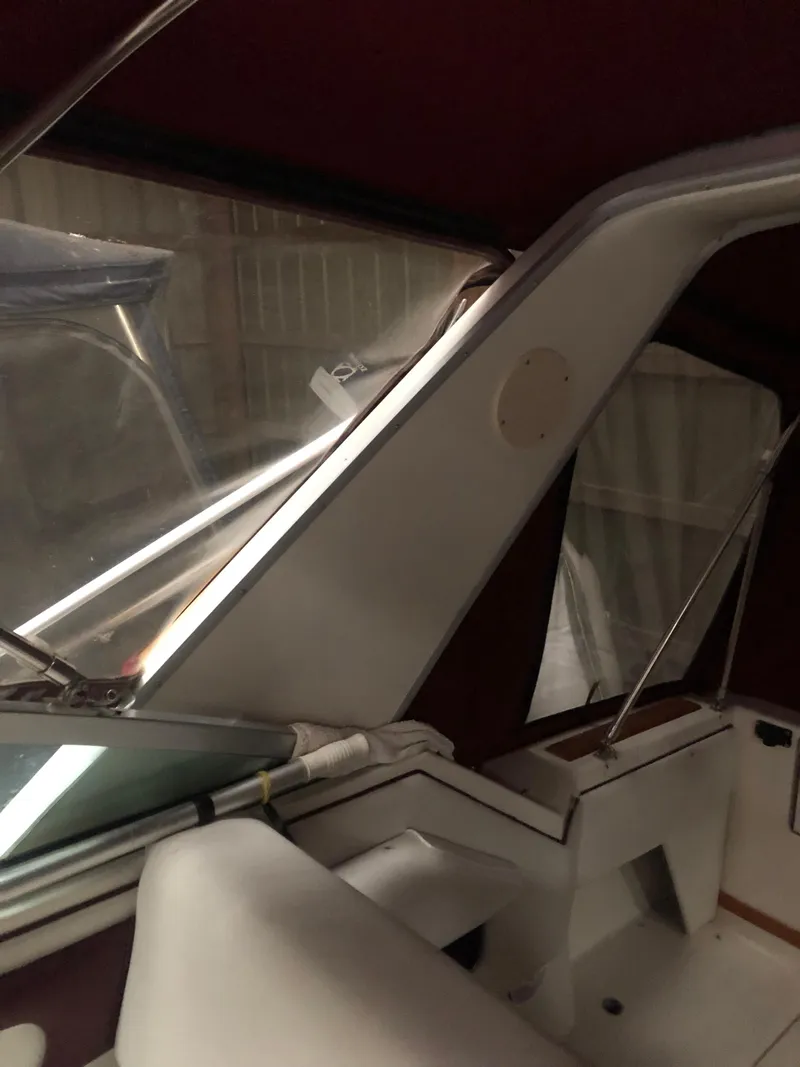Slide: The Image of 1989 Sea Ray 280 Sundancer interior with maroon accents and seating area. - 39