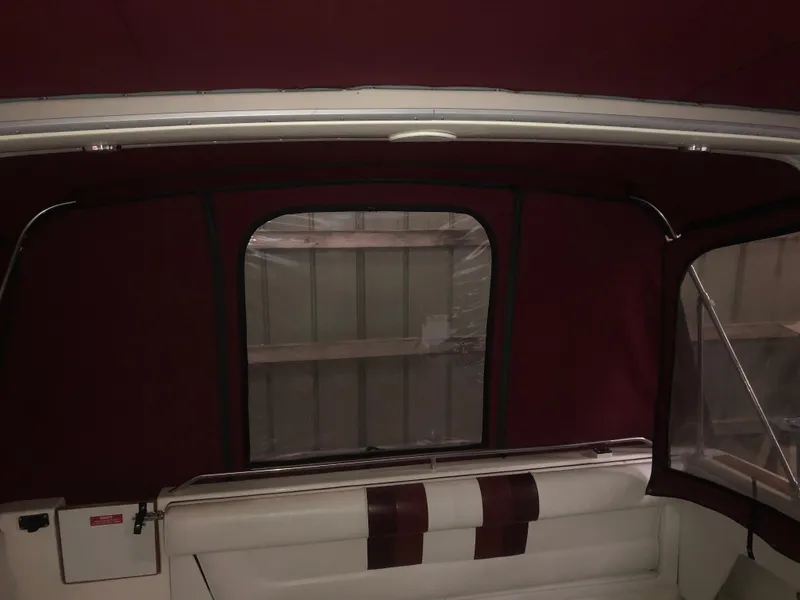 Slide: The Image of 1989 Sea Ray 280 Sundancer interior with maroon canopy and white seating. - 40
