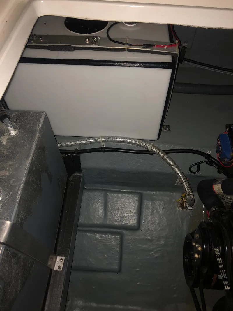 Slide: The Image of Engine compartment of 1989 Sea Ray 280 Sundancer boat, showing mechanical components and wiring. - 45