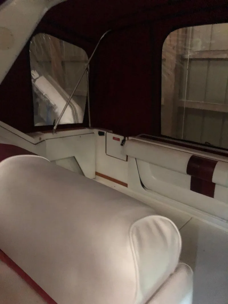 Slide: The Image of 1989 Sea Ray 280 Sundancer interior with white and maroon seating. - 8