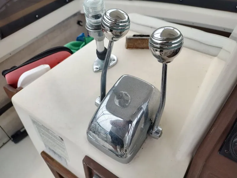 Slide: The Image of 1988 Trojan F32 Sedan boat throttle controls with dual levers and chrome finish. - 19