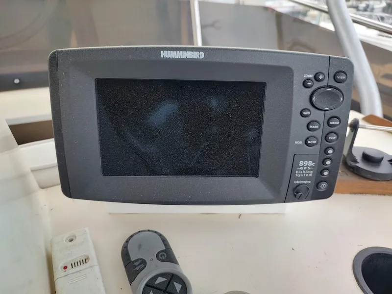 Slide: The Image of Humminbird GPS fish finder on 1988 Trojan F32 Sedan boat dashboard. - 21