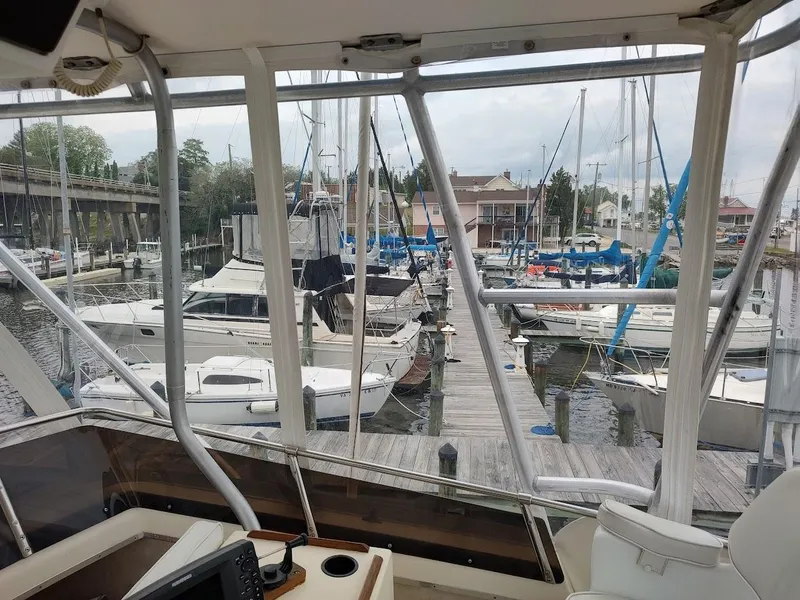 Slide: The Image of View from 1988 Trojan F32 Sedan, overlooking marina with docked sailboats and yachts. - 28