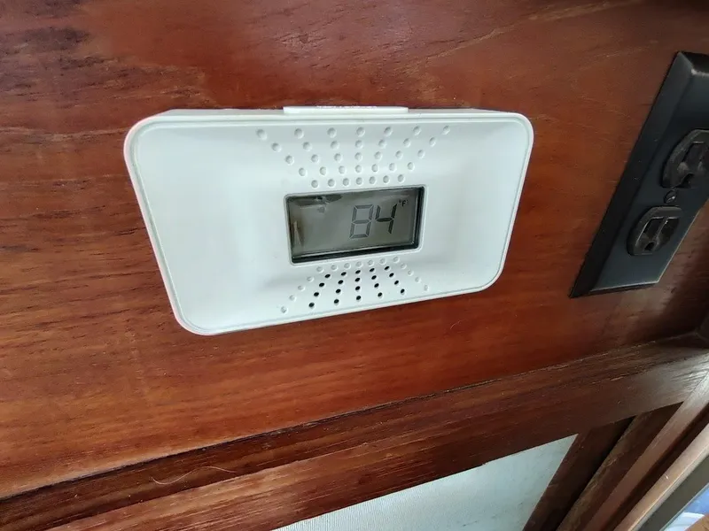 Slide: The Image of Digital thermometer displaying 84°F inside a 1988 Trojan F32 Sedan boat. - 40