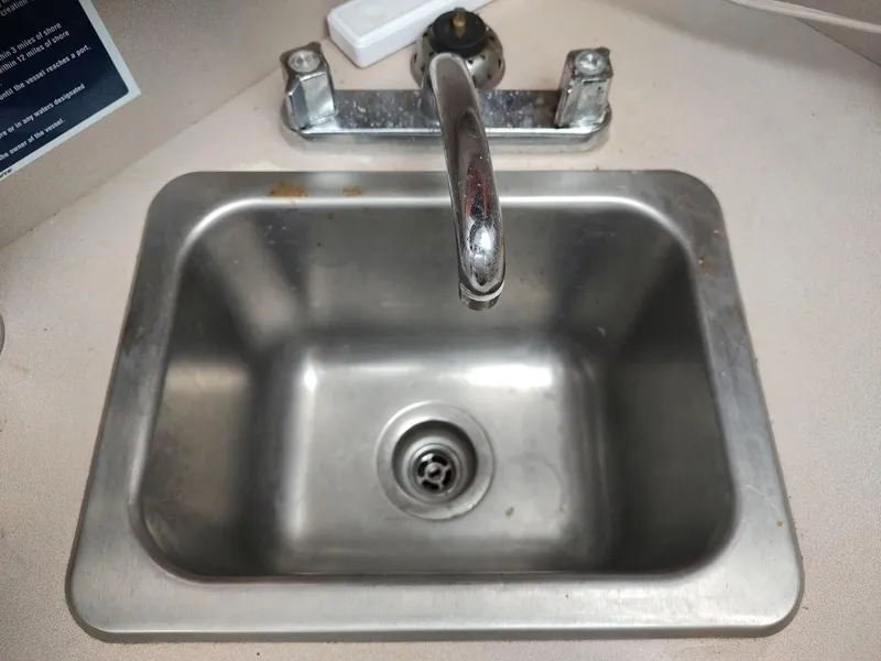 Slide: The Image of Stainless steel sink with faucet in 1988 Trojan F32 Sedan boat. - 46