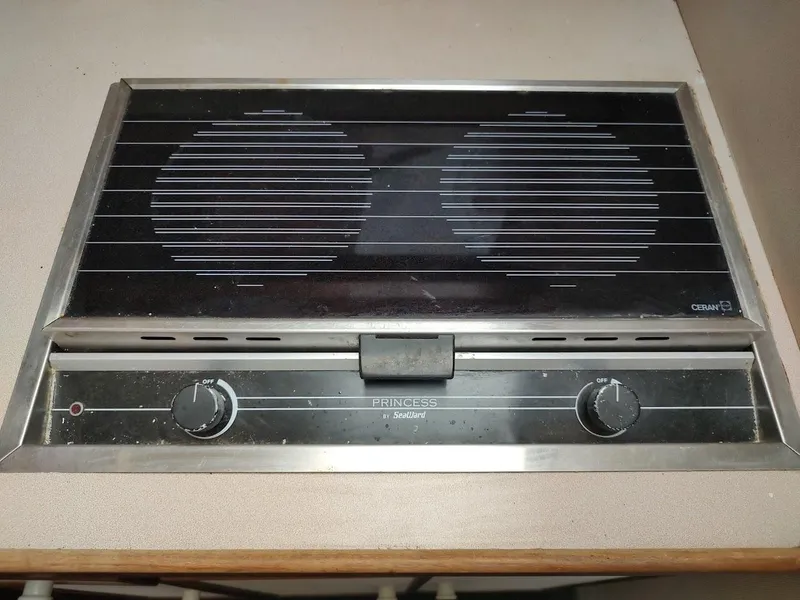 Slide: The Image of 1988 Trojan F32 Sedan stove with dual burners and control knobs. - 47