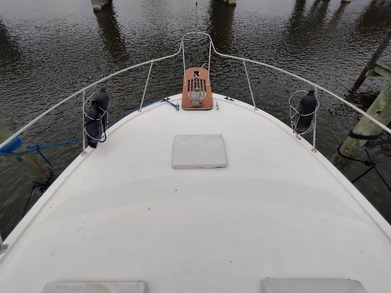Slide: The Image of 1988 Trojan F32 Sedan boat deck view at a marina. - 7