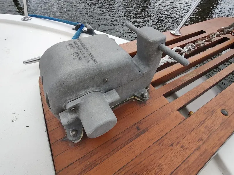 Slide: The Image of Windlass on 1988 Trojan F32 Sedan boat deck, near water. - 9