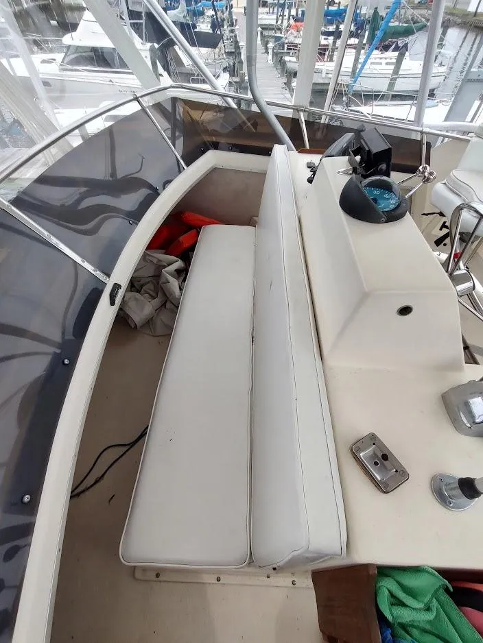 Slide: The Image of 1988 Trojan F32 Sedan boat interior with white seating and control panel. - 15