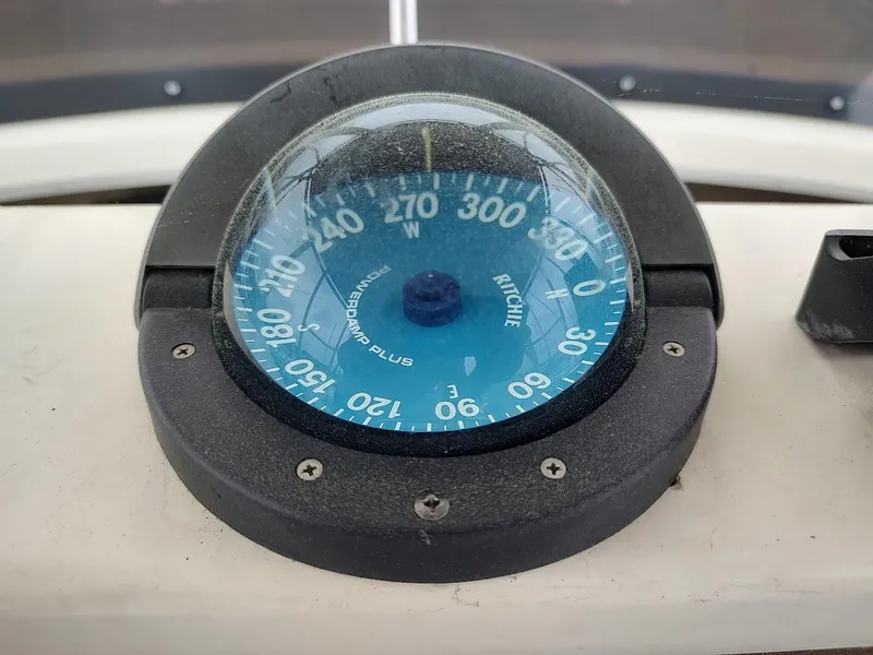 Slide: The Image of Compass on 1988 Trojan F32 Sedan boat dashboard, showing direction and degrees. - 20