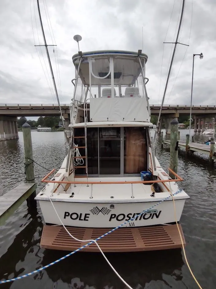 Slide: The Image of 1988 Trojan F32 Sedan boat docked, rear view with "Pole Position" text. - 3
