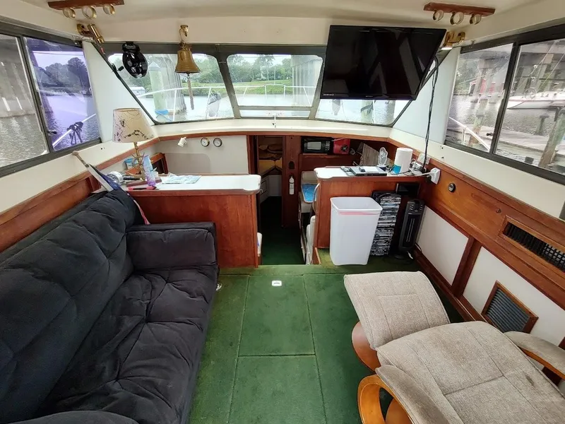 Slide: The Image of Interior of a 1988 Trojan F32 Sedan boat with cozy seating and modern amenities. - 35