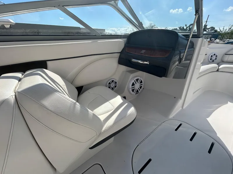 Slide: The Image of 2010 Four Winns H210 boat interior with white leather seats and dashboard. - 10