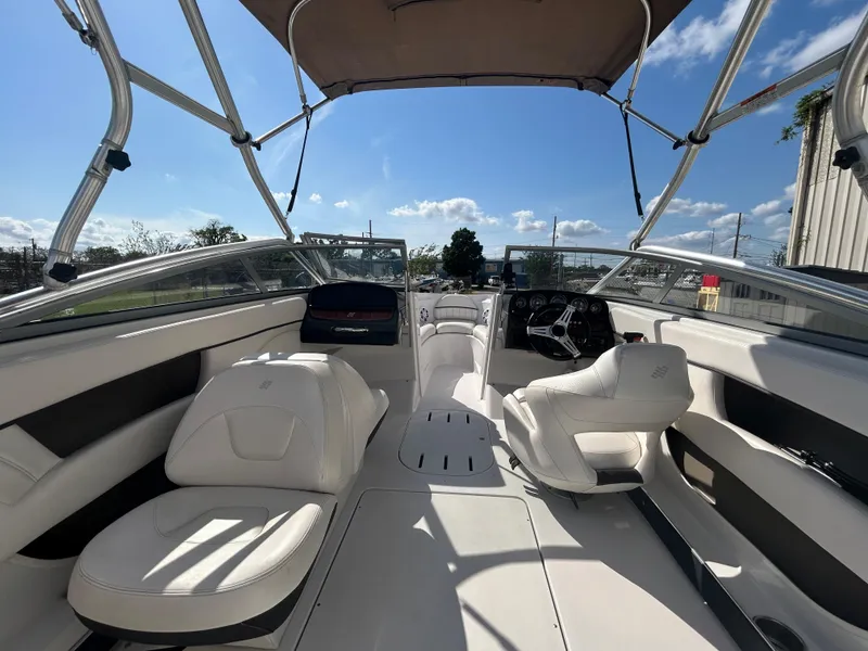 Slide: The Image of 2010 Four Winns H210 boat interior with white seating and canopy. - 12