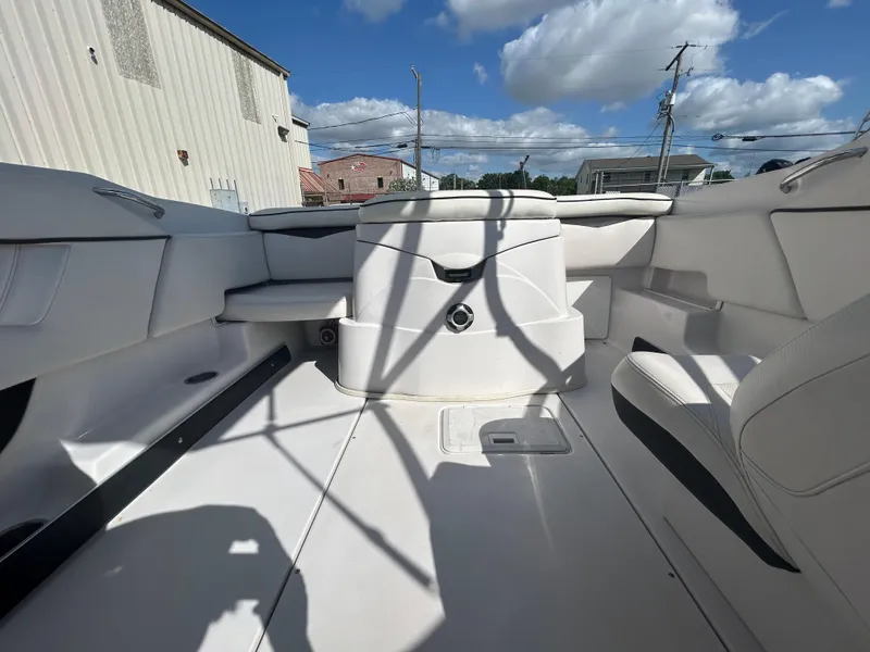 Slide: The Image of Interior of a 2010 Four Winns H210 boat with white seating and storage compartments. - 15