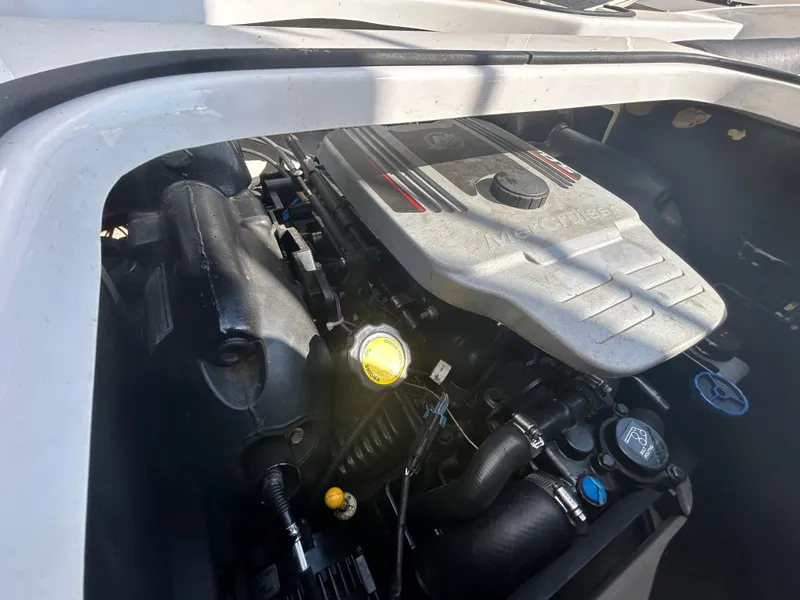 Slide: The Image of 2010 Four Winns H210 boat engine compartment with visible engine components. - 16
