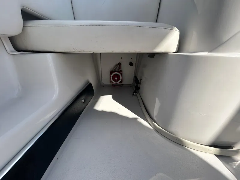 Slide: The Image of 2010 Four Winns H210 boat interior, featuring seating and storage compartment. - 24