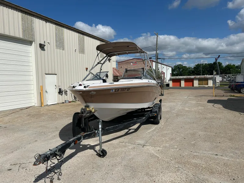 Slide: The Image of 2010 Four Winns H210 boat on trailer outside storage facility. - 6