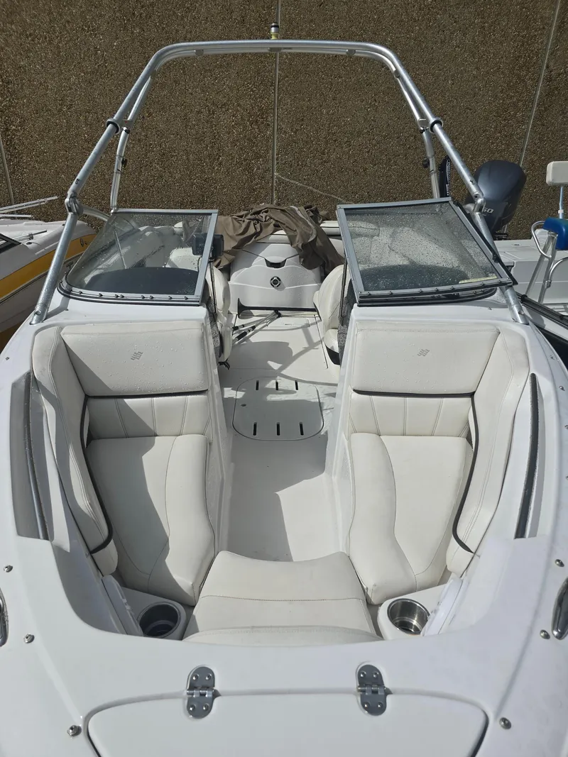 Slide: The Image of 2010 Four Winns H210 boat with white interior and open bow seating. - 9