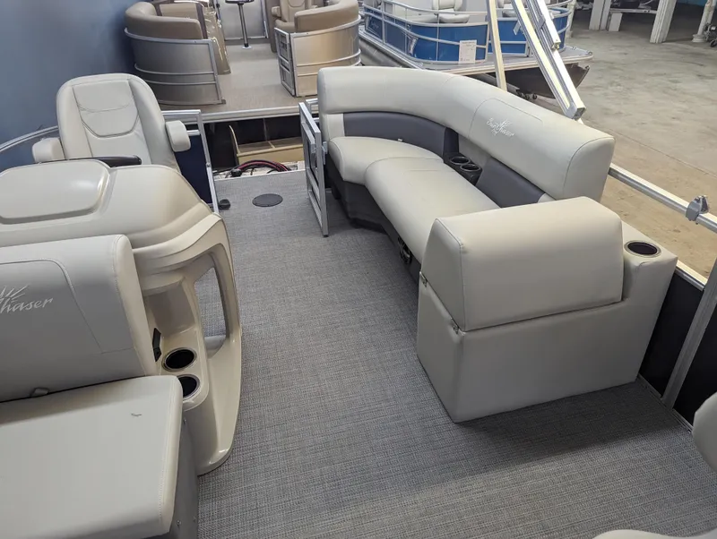Slide: The Image of 2024 SunChaser Vista 16 Fish pontoon boat interior with gray seating and carpet. - 5