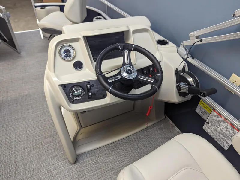 Slide: The Image of 2024 SunChaser Vista 16 Fish boat helm with steering wheel and control panel. - 8