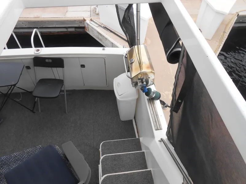 Slide: The Image of 1988 Cruisers Yachts 4280 Express Bridge deck with seating and fishing equipment. - 10