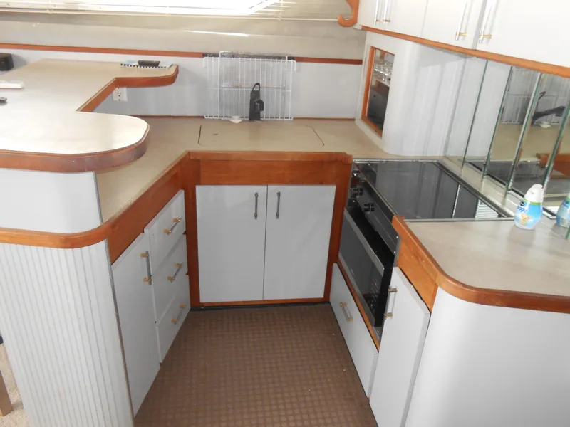Slide: The Image of 1988 Cruisers Yachts 4280 Express Bridge kitchen with modern appliances and ample storage. - 13