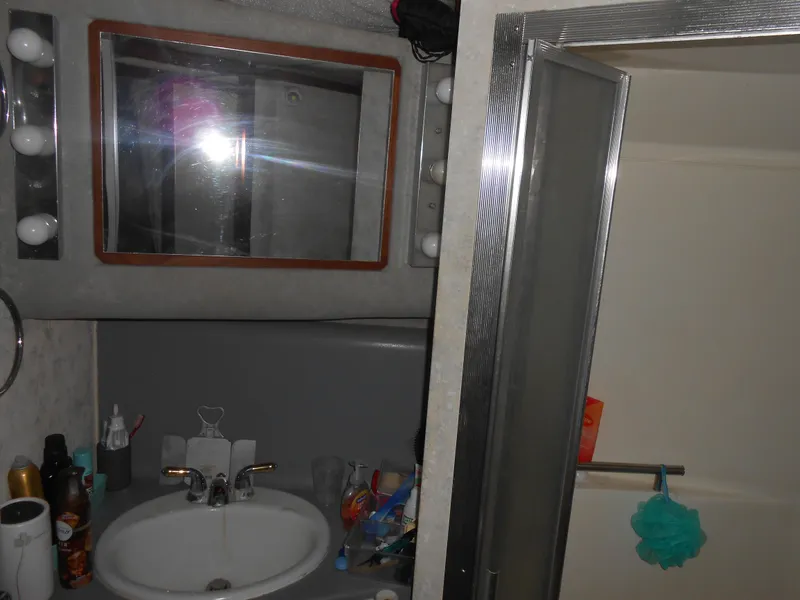 Slide: The Image of Bathroom vanity and shower in 1988 Cruisers Yachts 4280 Express Bridge. - 16
