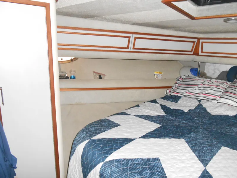 Slide: The Image of 1988 Cruisers Yachts 4280 Express Bridge cabin with bed and storage. - 19